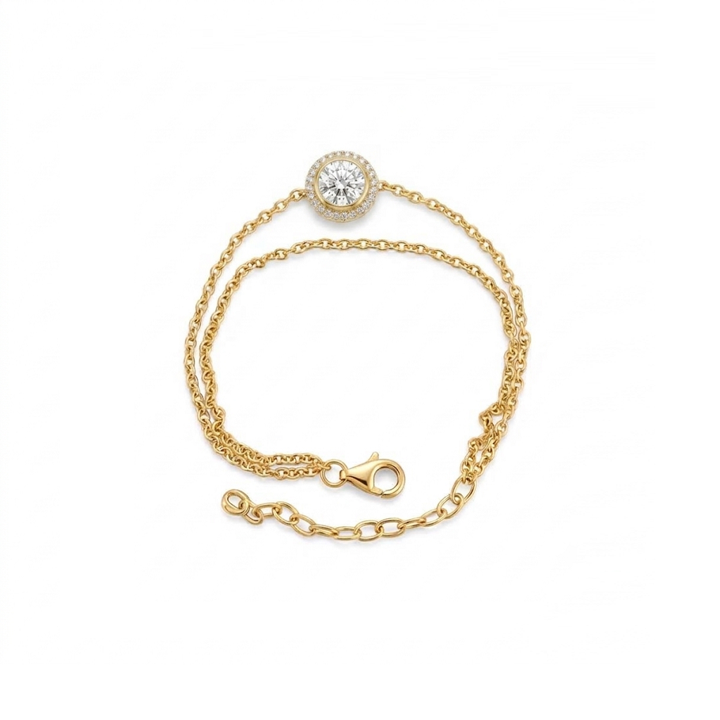 A delicate yellow gold chain bracelet featuring a round bezel-set clear gemstone at the center, displayed on a clean white background.