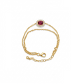 A delicate yellow gold chain bracelet featuring an oval-cut pinkish-red central stone surrounded by a halo of small clear stones, shown on a plain white background.