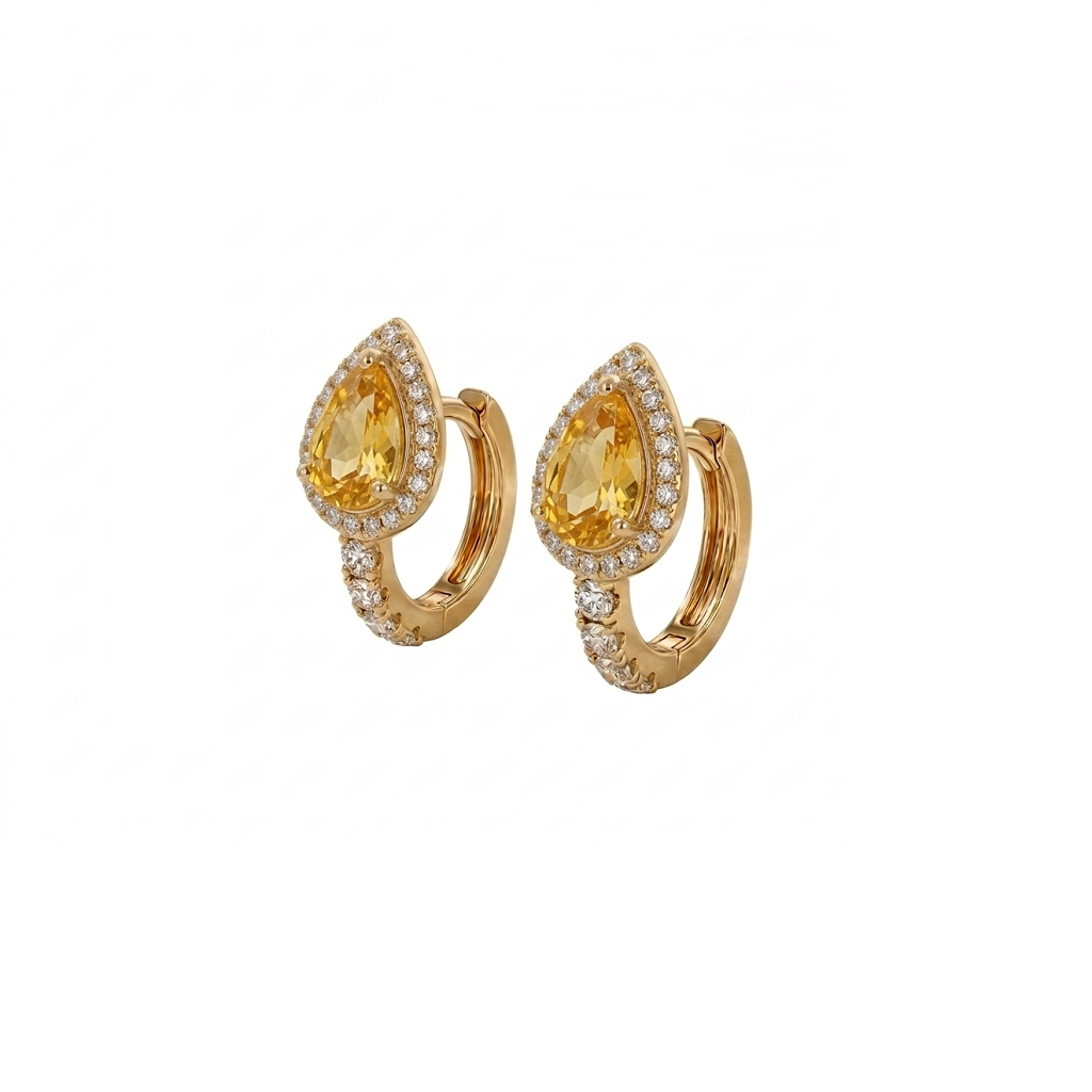 A pair of gold huggie hoop earrings featuring a teardrop-shaped yellow gemstone in a halo setting, accented with small pavé-set clear stones along the lower curve, shown on a plain white background.